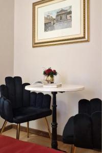 a table with two chairs and a table with a picture at Affittacamere Boncompagni Suite in Rome
