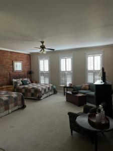 a large living room with a bed and a couch at Eagles Nest Inn in Louisiana