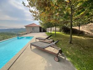 a bench sitting next to a swimming pool at Casa da Prelada in Amarante