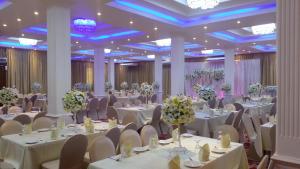 a banquet hall with white tables and chairs at Navro Beach Resort in Panadura
