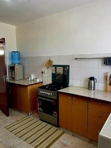 a kitchen with a stove and a counter top at Kisumu 3 bedroom Apartment Elegant in Kisumu