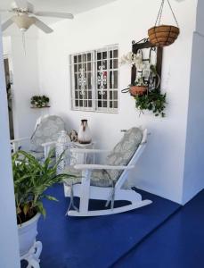 a room with a white table and chairs and plants at Hermosa casa Holandesa in La Entrada