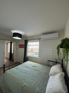 a bedroom with a large bed and a window at Apartement Anabela in Willemstad