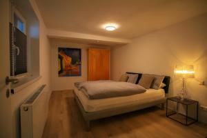 ein Schlafzimmer mit einem Bett und einer Lampe in der Unterkunft FReiraum in Güttingen