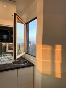 a kitchen with a sink and a window at Apartment HOME in Paris with View, 15min to center in Paris