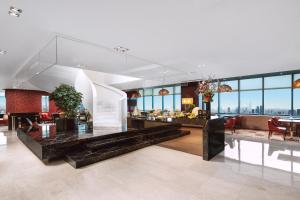 a large living room with a view of the city at Renaissance Shanghai Zhongshan Park Hotel in Shanghai