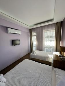 a hotel room with two beds and a window at Lara Kapris Hotel in Antalya