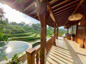 a porch of a house with a view of a field at Abian Ayu Villa in Sidemen