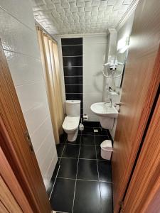 a small bathroom with a toilet and a sink at Lara Kapris Hotel in Antalya +21 photos