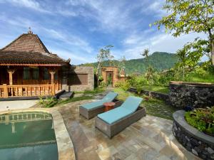 a backyard with a pool and a house at Abian Ayu Villa in Sidemen