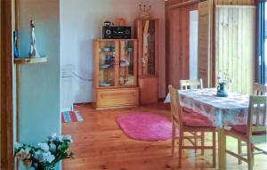 a dining room with a table and chairs at Awesome Apartment In Leba With Sauna in Łeba