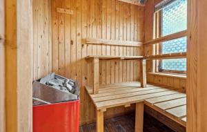 a wooden sauna with a red trash can in it at 3 Bedroom Pet Friendly Home In Højslev in Højslev +14 photos