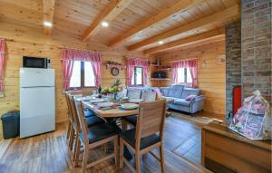 a kitchen and dining room with a table in a cabin at Beautiful Home In Vinogradi Ludbreski With Heated Swimming Pool in Ludbreg