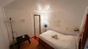 a hospital room with a white bed and a light at Islo Hut Kanan in General Luna