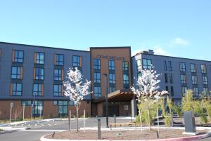 a building with trees in front of it at Cedartree Hotel Portland Hillsboro in Hillsboro