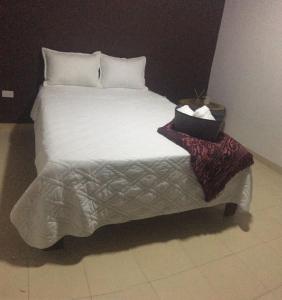 a bedroom with a bed with a box of tissues on it at Casa Mar Riohacha in Ríohacha