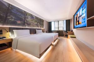 Ένα ή περισσότερα κρεβάτια σε δωμάτιο στο True Go Hotel Nanshan Shenzhen