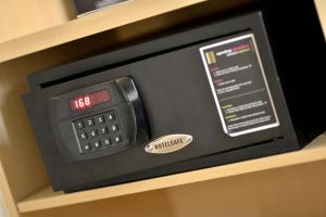 an alarm clock on a shelf with a clock on it at Zodiak Sutami by KAGUM Hotels in Bandung
