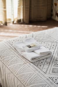 a white towel sitting on top of a bed at Urban Sanctuary on Union in Dunedin