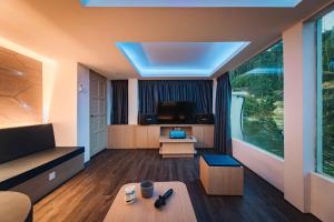 a living room with a couch and a tv at ELLIN FOREST 叶の森 in Tok Tok