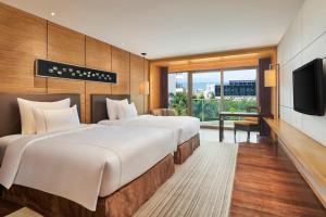 Voodi või voodid majutusasutuse Shenzhen Dameisha Kingkey Palace Hotel toas