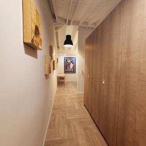 a hallway with wooden floors and a hallway with paintings on the walls at Private Home Studio Central Located in Miami 2 in Opa-locka