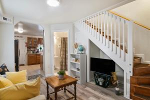 a living room with a staircase and a couch at Quintessential Charm in Downtown Annapolis in Annapolis