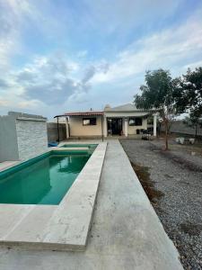 a swimming pool in front of a house at Casa de las estrellas in Valles