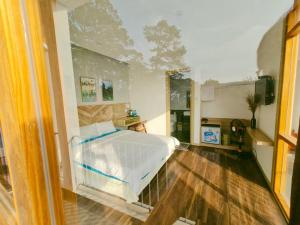 a bedroom with a white bed in a room at Vindy House in Da Lat