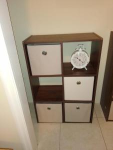 a dresser with a clock on top of it at The Sweet Oasis 2 bedroom Apartment in Nassau