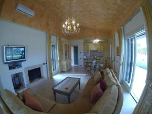 a living room with a couch and a fireplace at Villa Stella Relax in Saturnia