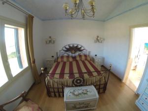 a bedroom with a bed and a chandelier at Villa Stella Relax in Saturnia
