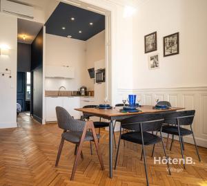 a kitchen and dining room with a table and chairs at The "Heritage" Heart of Limoges Parking AC and Private Terrace in Limoges