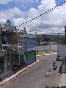 an empty street with a building and a river at Apartamentos Central in Triunfo
