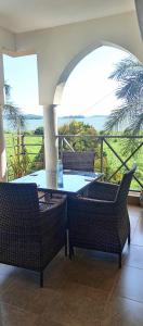 een patio met een tafel en stoelen op een balkon bij Luzira port bell lake side apartment in Kampala