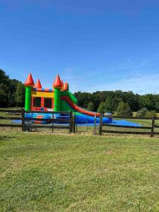 a playground with a water slide in a field at Sovereign Cottage - Farm Land/Hot Tub/Outdoor Area in Fuquay-Varina