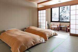 Een bed of bedden in een kamer bij Kogakuro