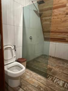 a bathroom with a toilet and a glass shower at El Sueño in San Bernardino