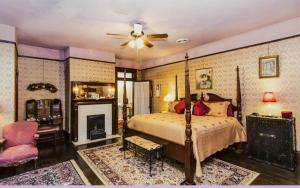 a bedroom with a bed and a fireplace at Simmons-Bond Inn Bed & Breakfast in Toccoa