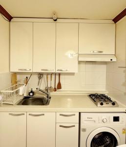 Una cocina con gabinetes blancos y un fregadero. en La Tulipe, en Seúl 6 fotos más