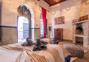 a bedroom with a bed with swans on it at Riad Mamma MARRAKESH in Marrakech