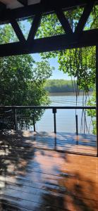 a wooden deck with a view of a body of water at Willo's Treehouse in Escuintla