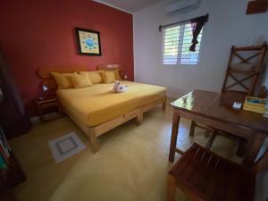 a bedroom with a bed with a stuffed animal on it at Casa Pascale in Punta Allen