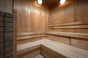 a sauna with wood paneling and two lights on at nol hakone myojindai in Hakone