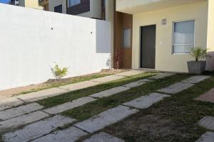 a walkway in front of a house with a building at Agradable Casa Madeira Tijuana Rosarito in Tijuana