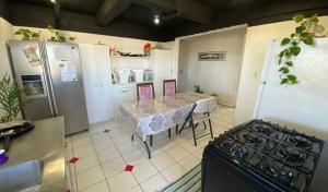 a kitchen with a table and a kitchen with a stove at Agradable hogar en Playas de Tijuana in Tijuana