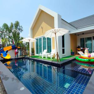 a house with a swimming pool with a playground and an inflatable at Pool Villa Udonthani in Udon Thani