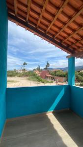 a blue wall with a view of a beach at Casa Azul do Capão in Palmeiras