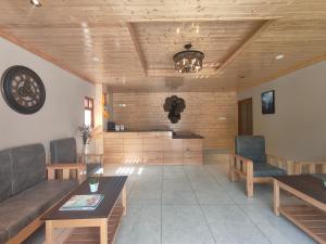 a living room with a couch and a table and chairs at Valmere Bayul Shangri-La Resort in Lachung
