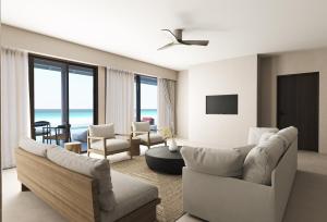 a living room with white furniture and a view of the ocean at Villa Haven Maldives Resort in Maamigili